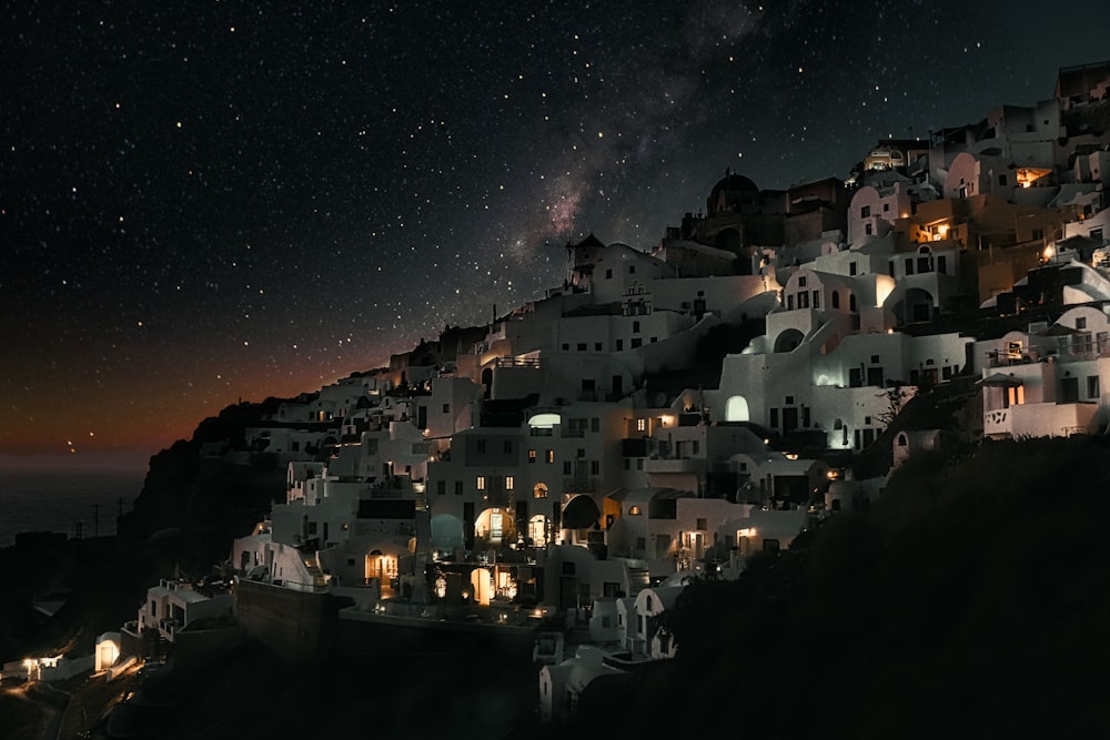 white and black houses near body of water during night time