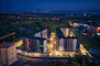 Night view of illuminated residential towers symbolizing modern living