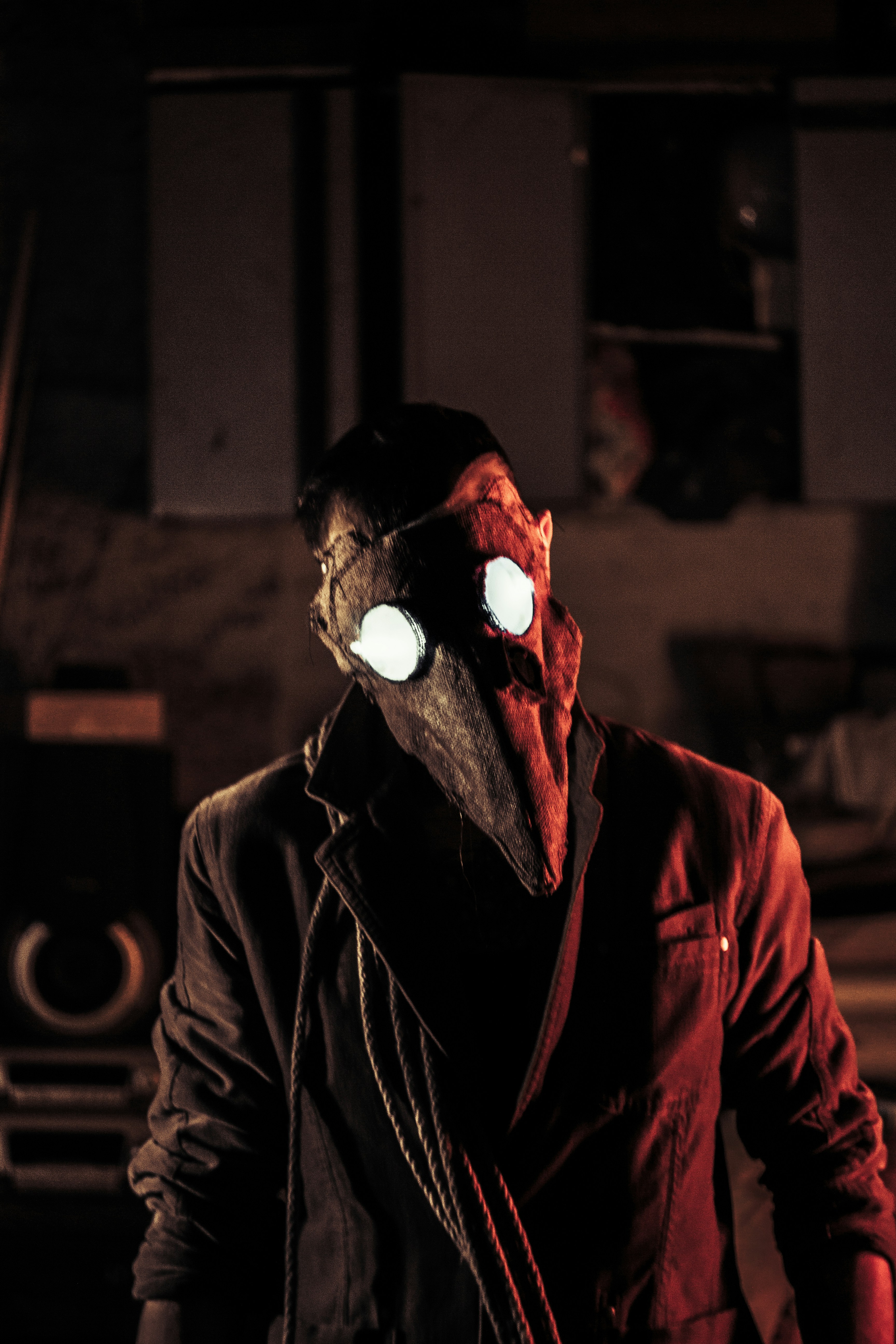 man in black leather jacket wearing red mask