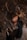 A person with closed eyes is surrounded by dense, dark foliage, creating a serene atmosphere. The leaves have a rich, brownish color contrasting with the smooth texture of the individual's skin. The composition gives a sense of being intertwined with nature.