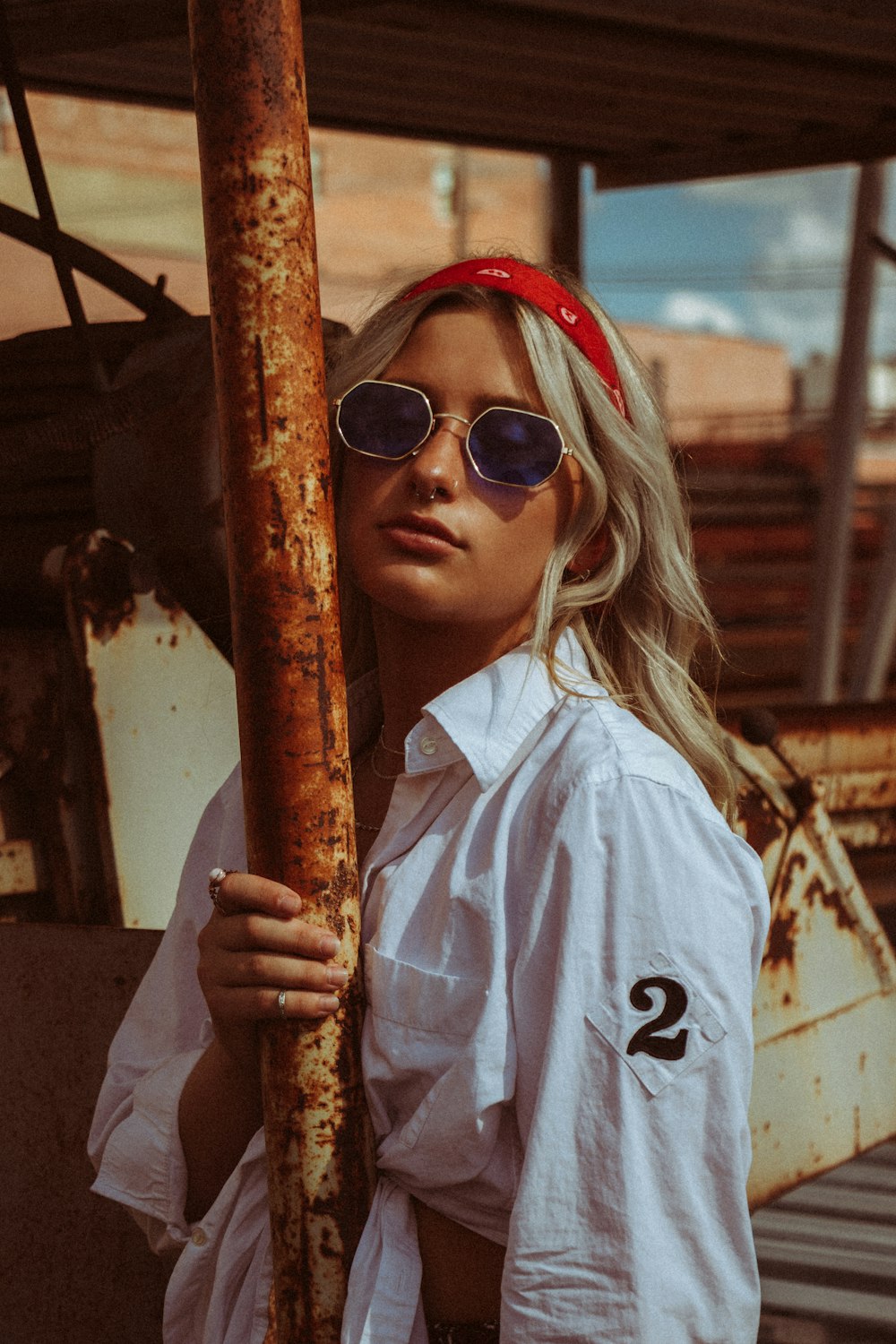 woman in white button up shirt wearing sunglasses