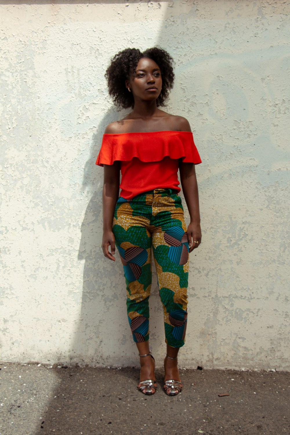 woman in red off shoulder shirt and blue and yellow pants