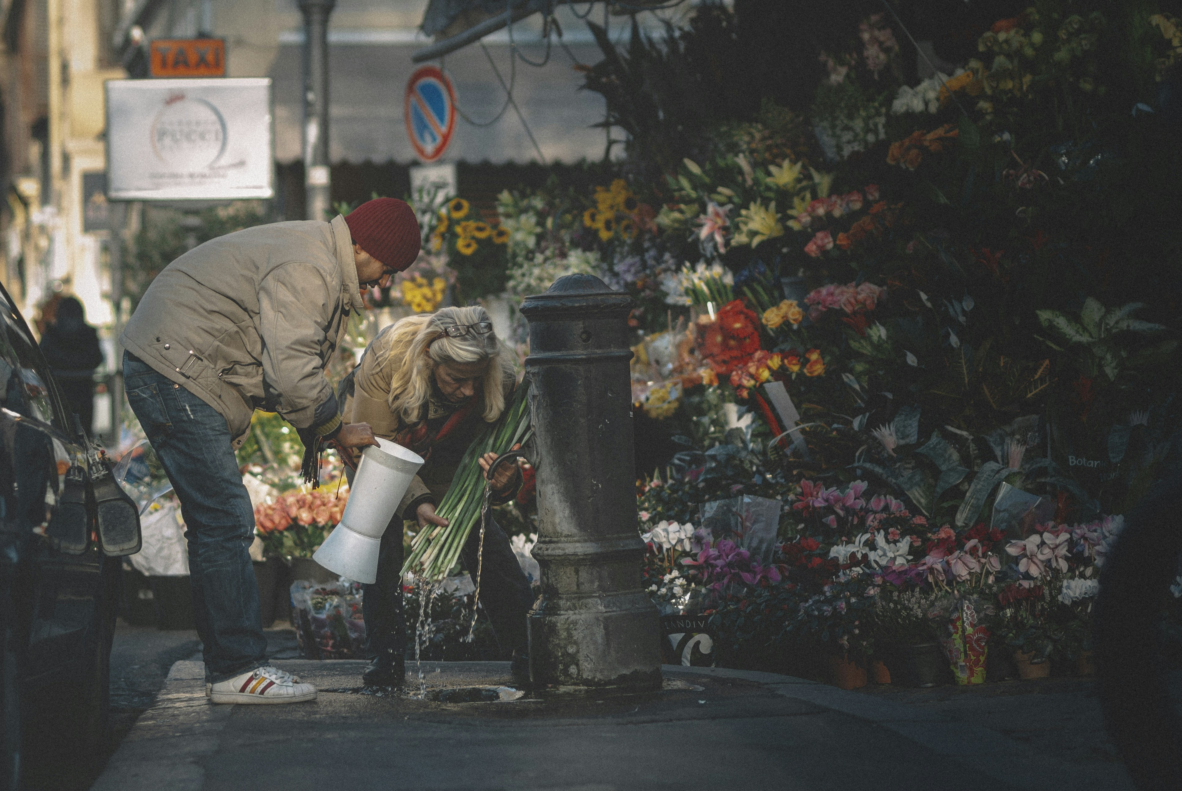 Flower sellers gather water from the water column.