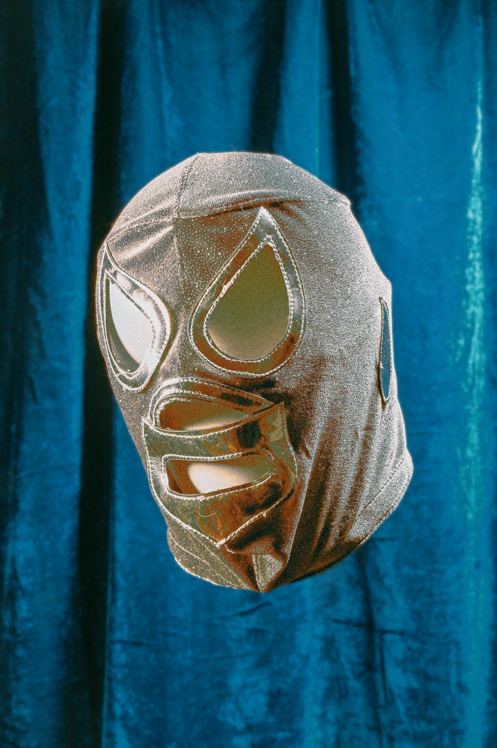 gray mask on blue textile