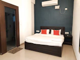 Cozy twin bedroom with modern decor and air conditioning.