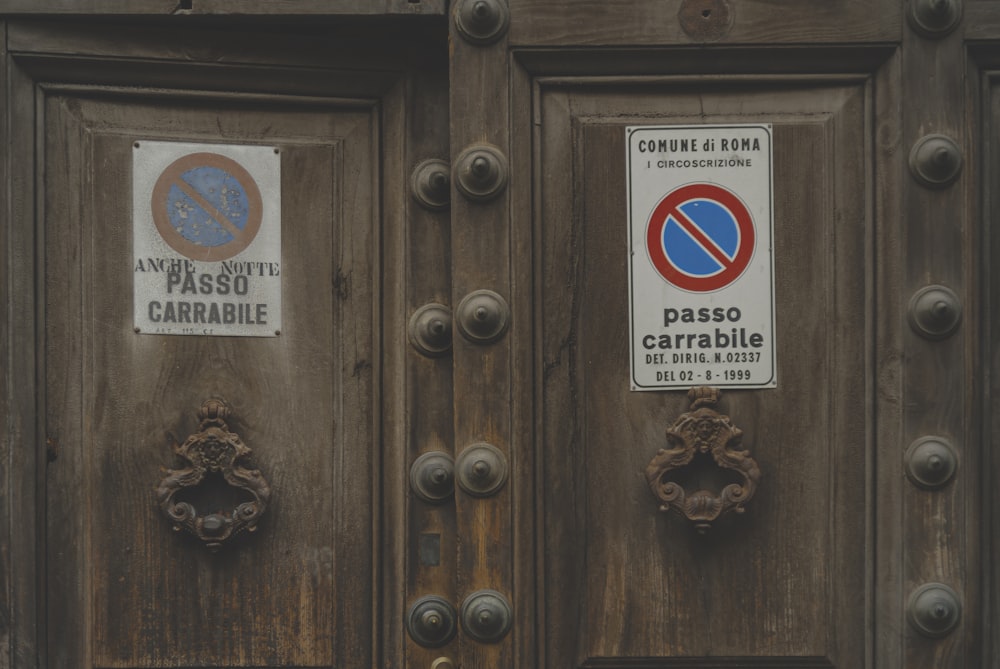 brown wooden door with white and red sticker