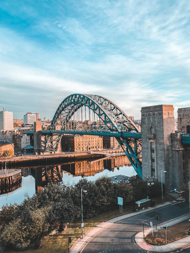 The Tyne Bridge in Newcastle reflected in the river on a clear day