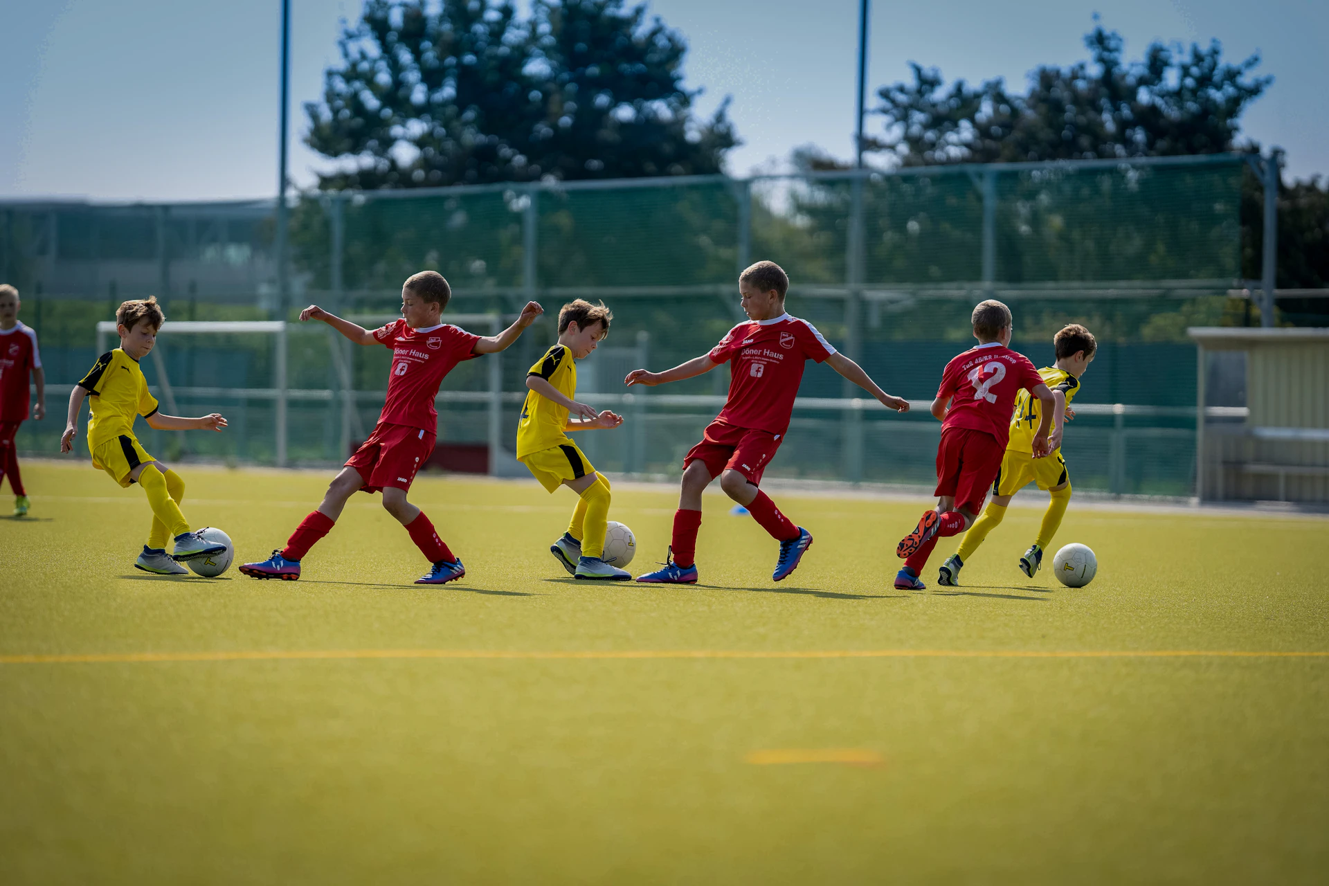 Group of men playing soccer during daytime.