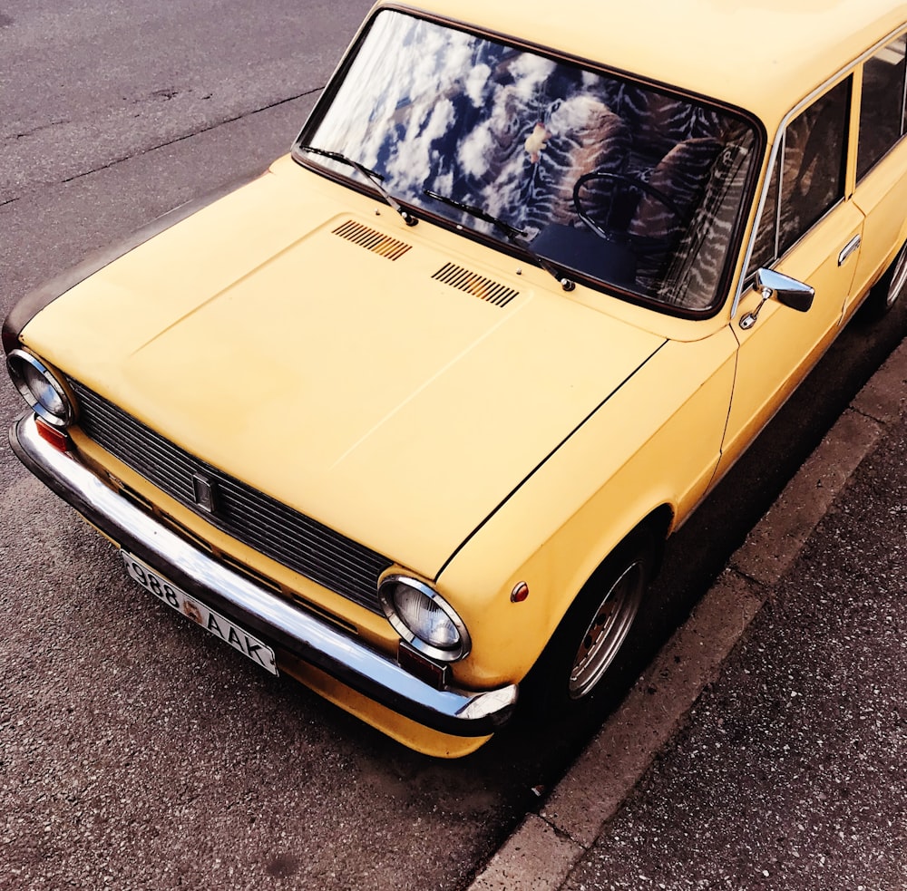 yellow classic car on road during daytime