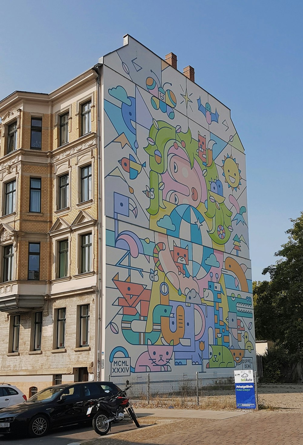 brown concrete building with blue and yellow graffiti