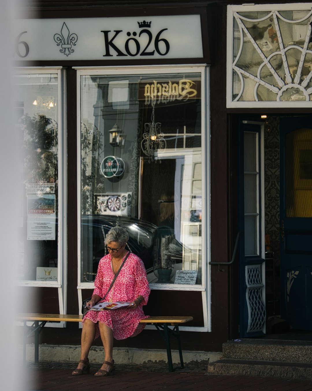 woman in pink and white dress sitting on chair