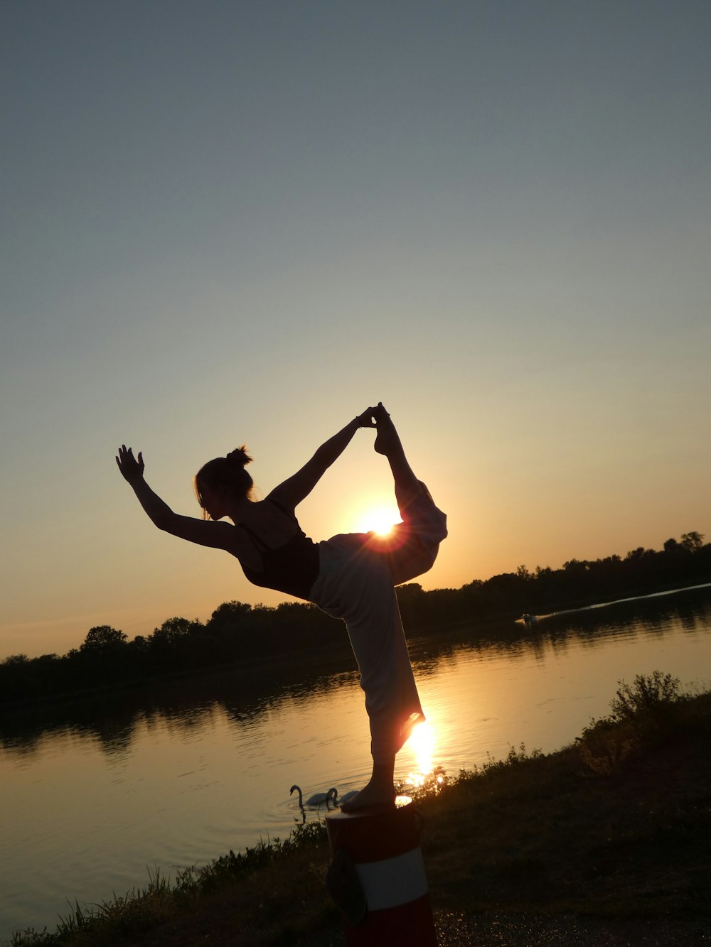 silhouette of man jumping on water during sunset