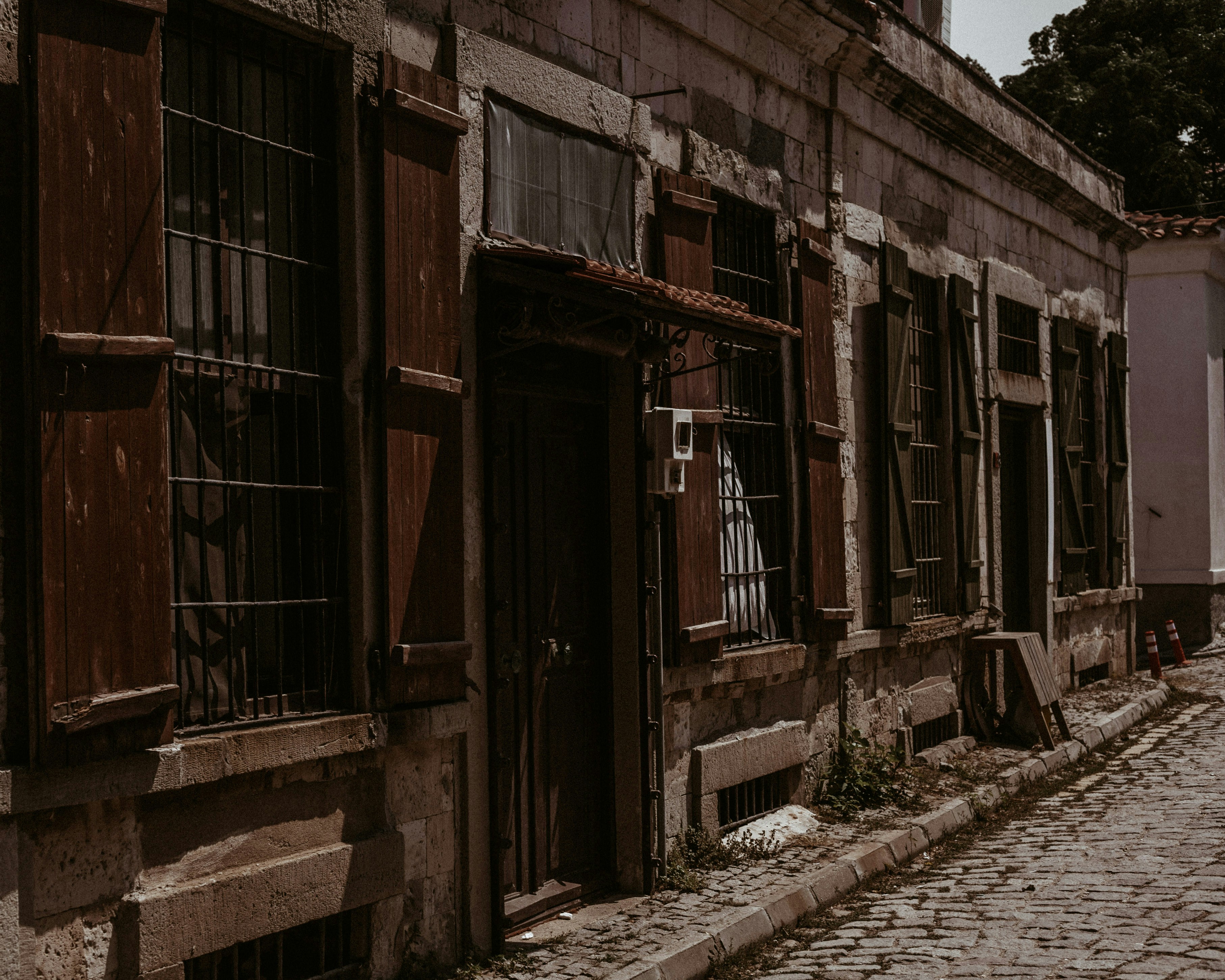 brown wooden door on gray concrete building during daytime