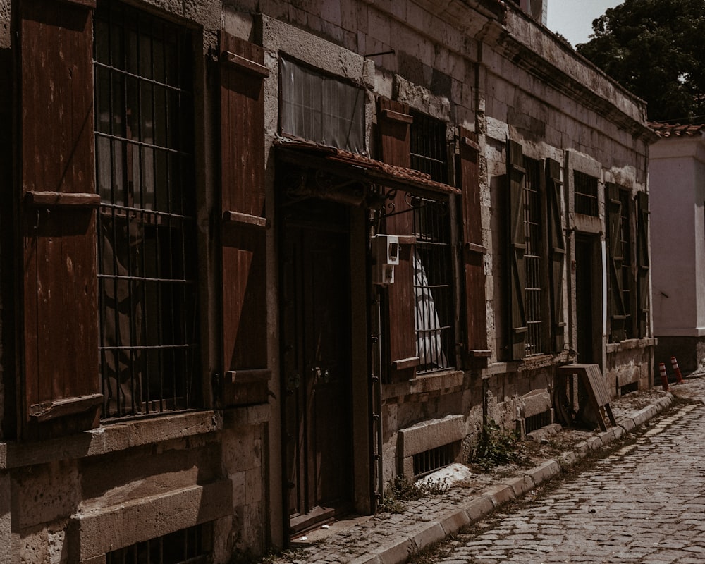 brown wooden door on gray concrete building during daytime