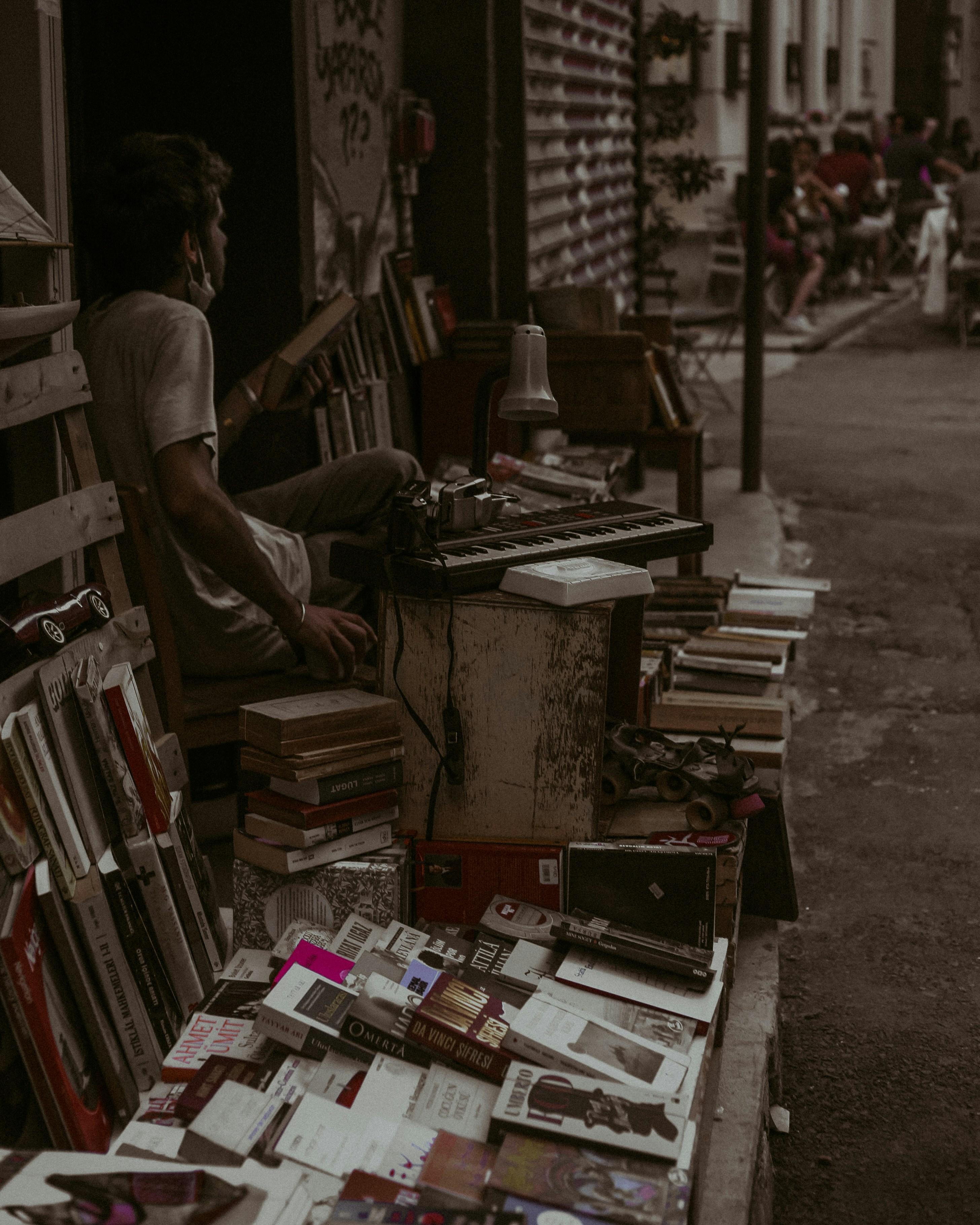 man in black t-shirt standing near books