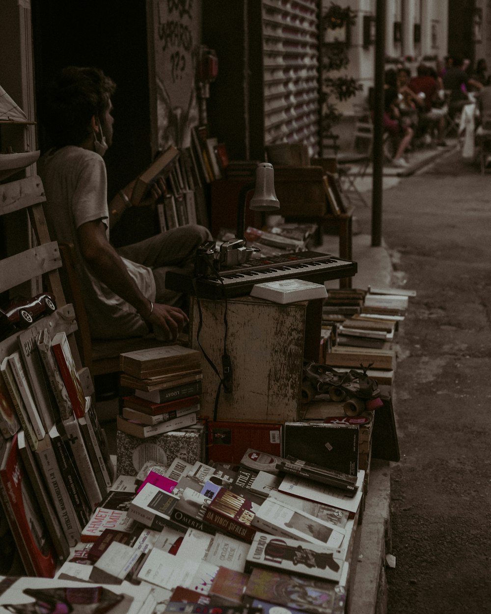 man in black t-shirt standing near books