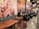 Smiling woman enjoying a slice of pizza at Fuegomasa's cozy dining area