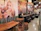 Cozy interior of Arte Bianca with customers chatting and enjoying their pizzas.