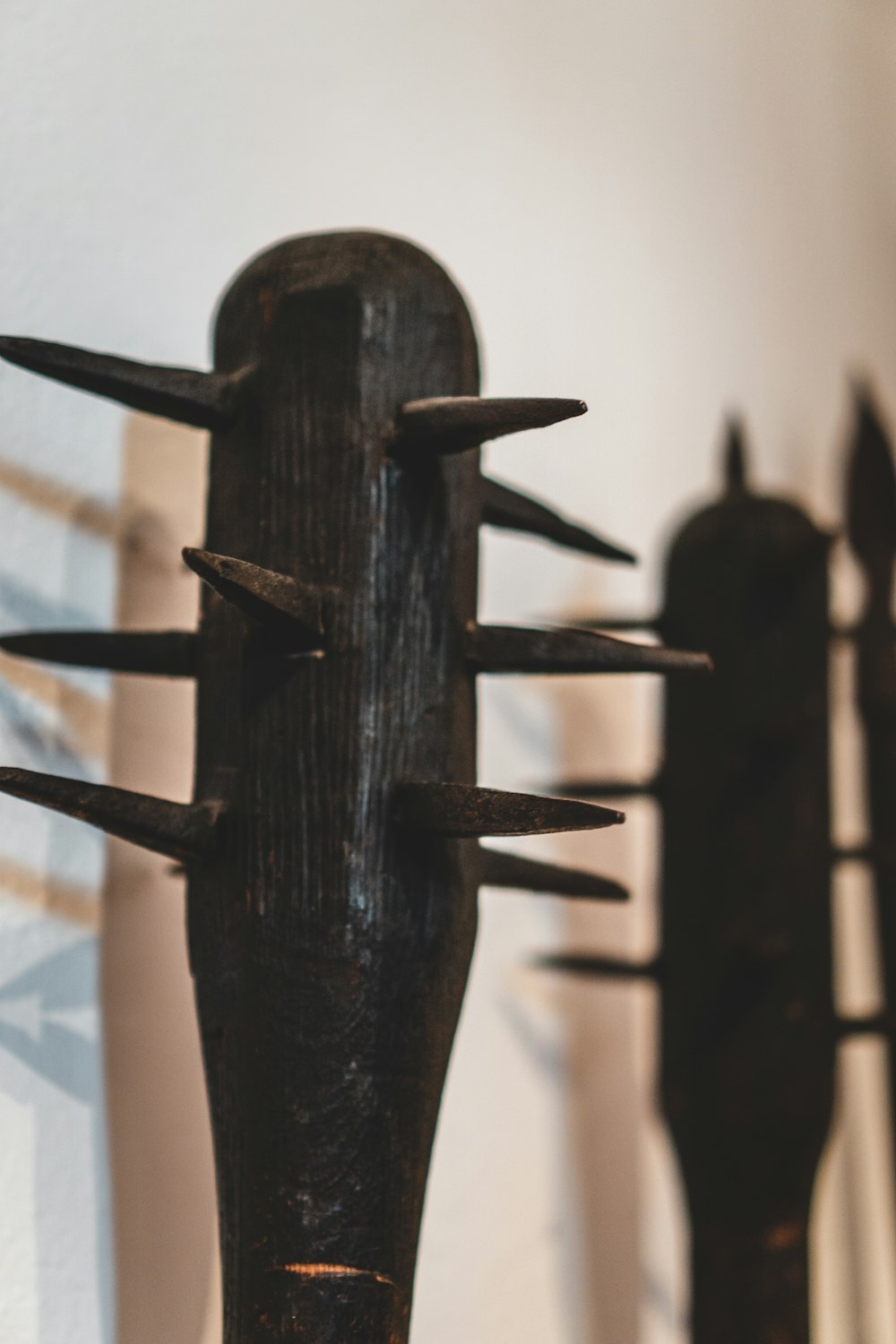 brown wooden cross with black metal frame