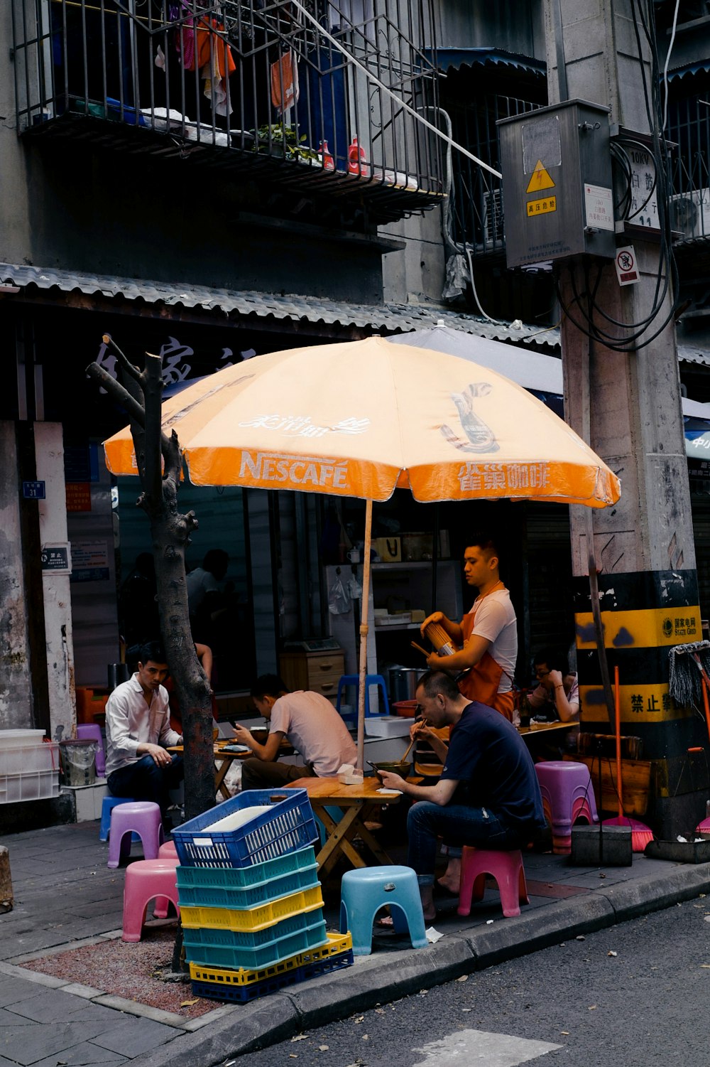 people sitting on chair near table and building during daytime