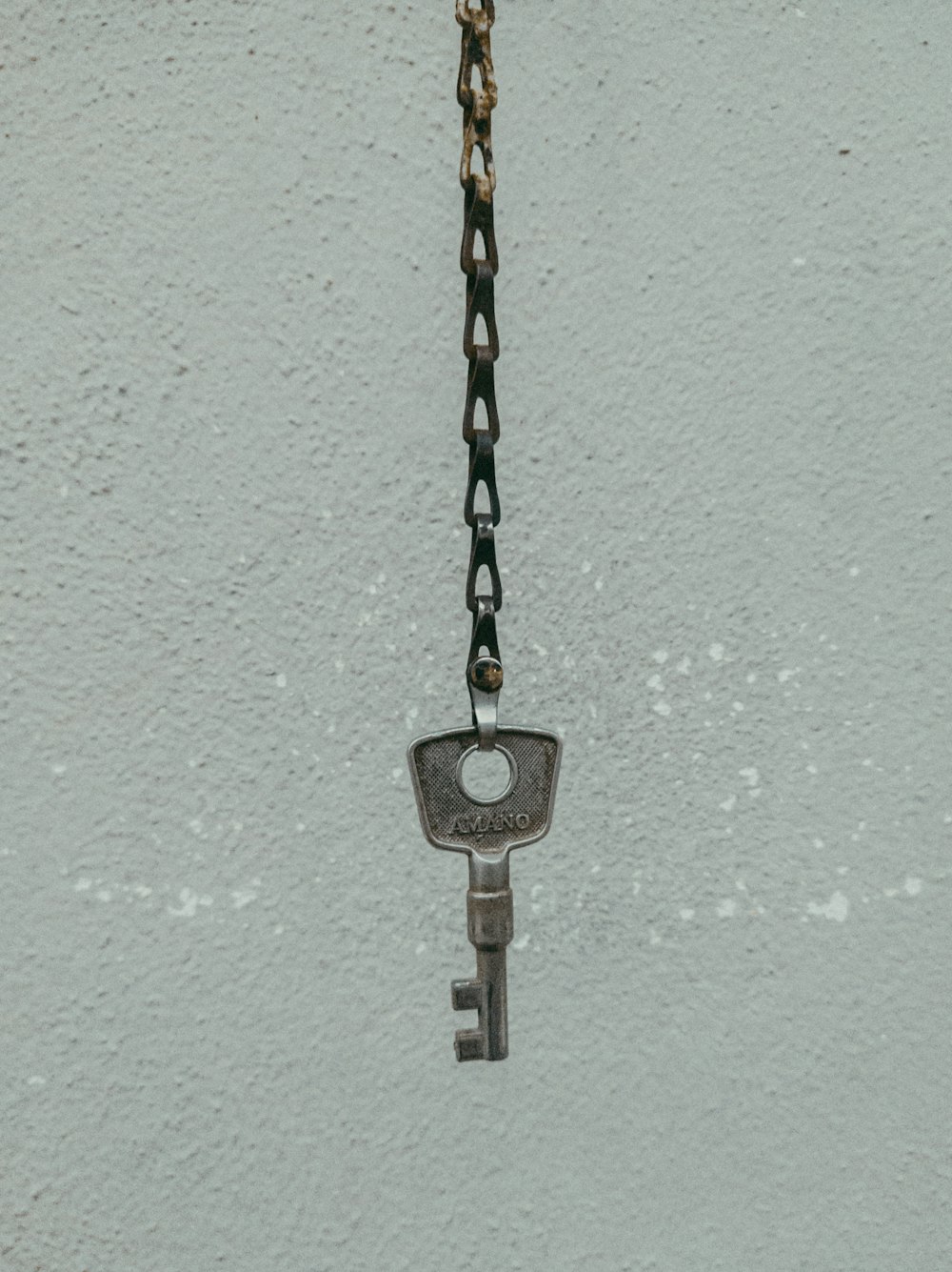silver padlock on teal painted wall