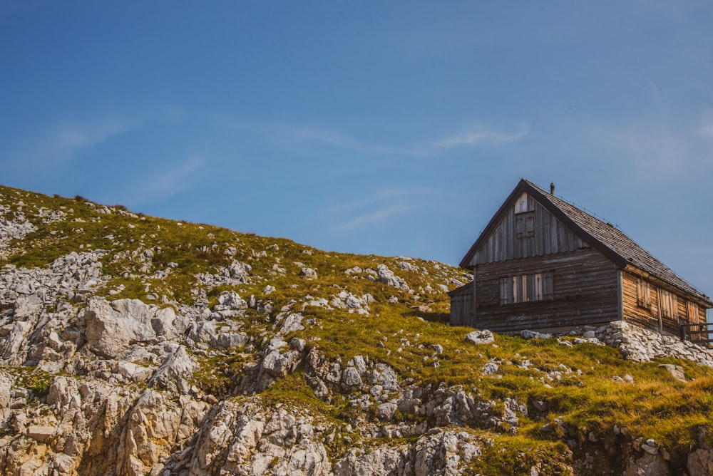 brown wooden house on green grass field during daytime