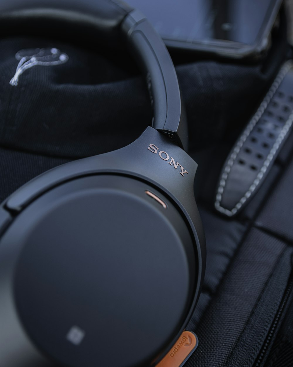 black sony headphones on black textile