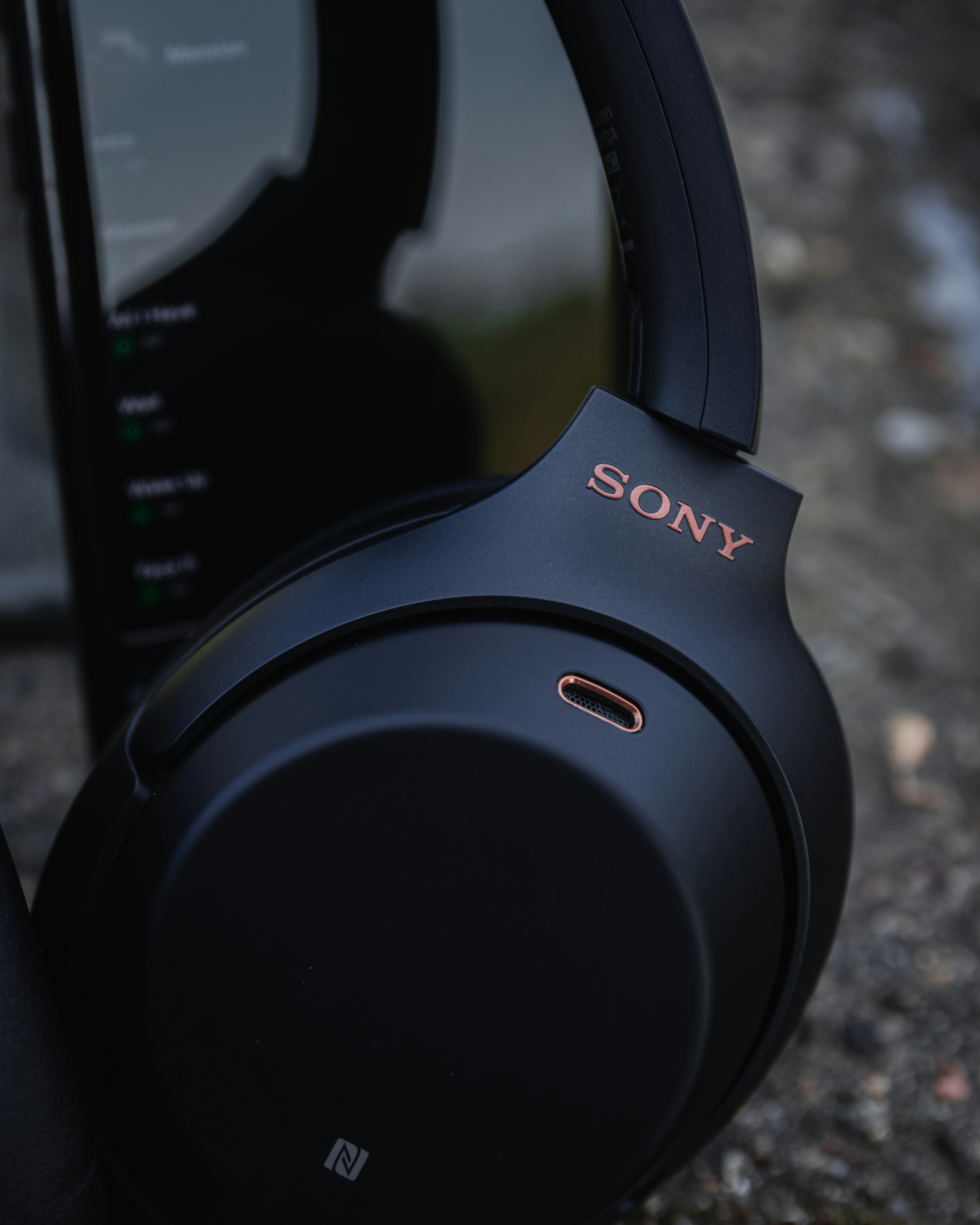 Headphones resting on on a phone. Ready to pick up and play some good music.