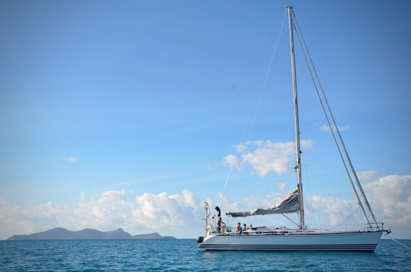 white sail boat on sea during daytime