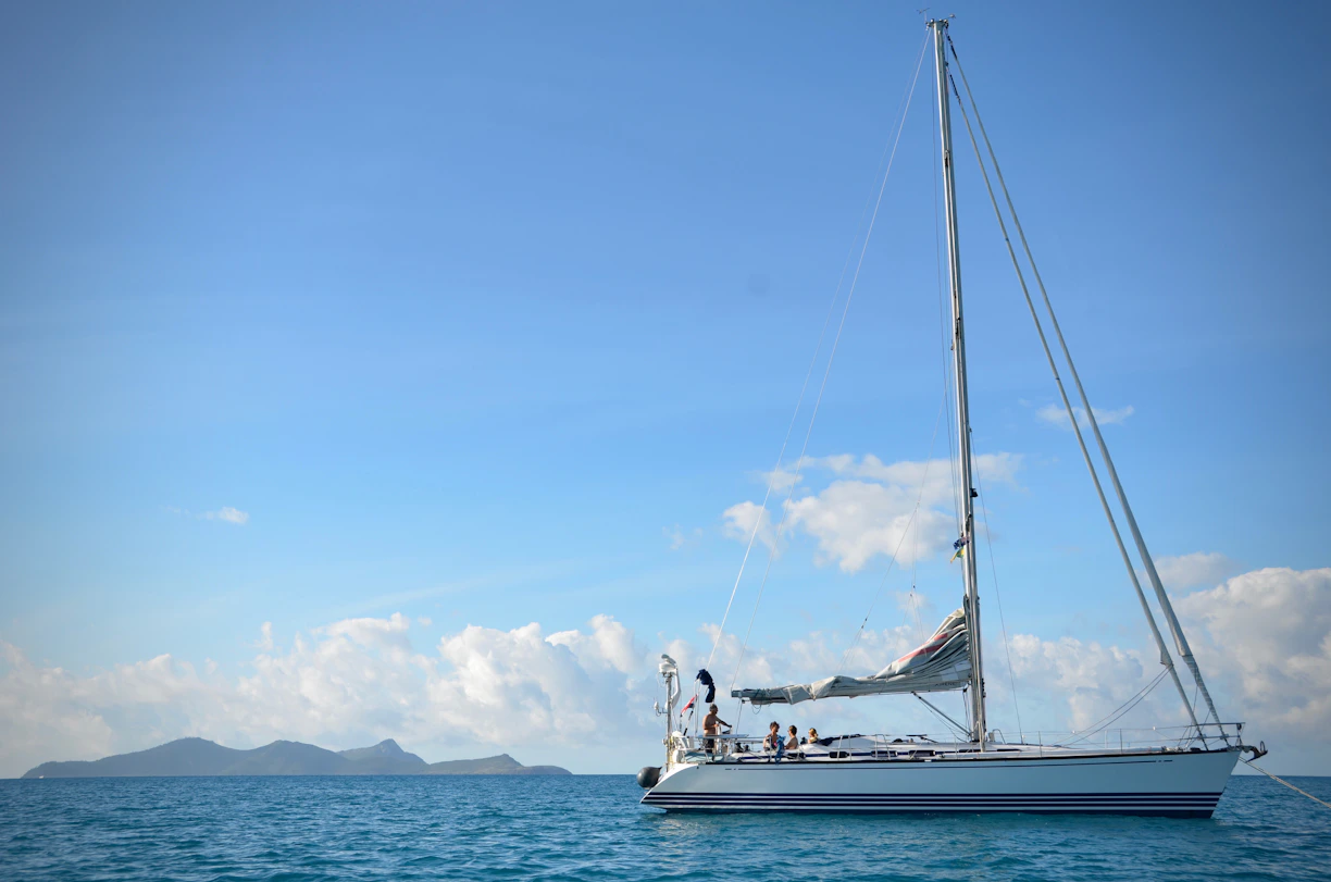white sail boat on sea during daytime