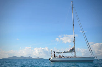 white sail boat on sea during daytime