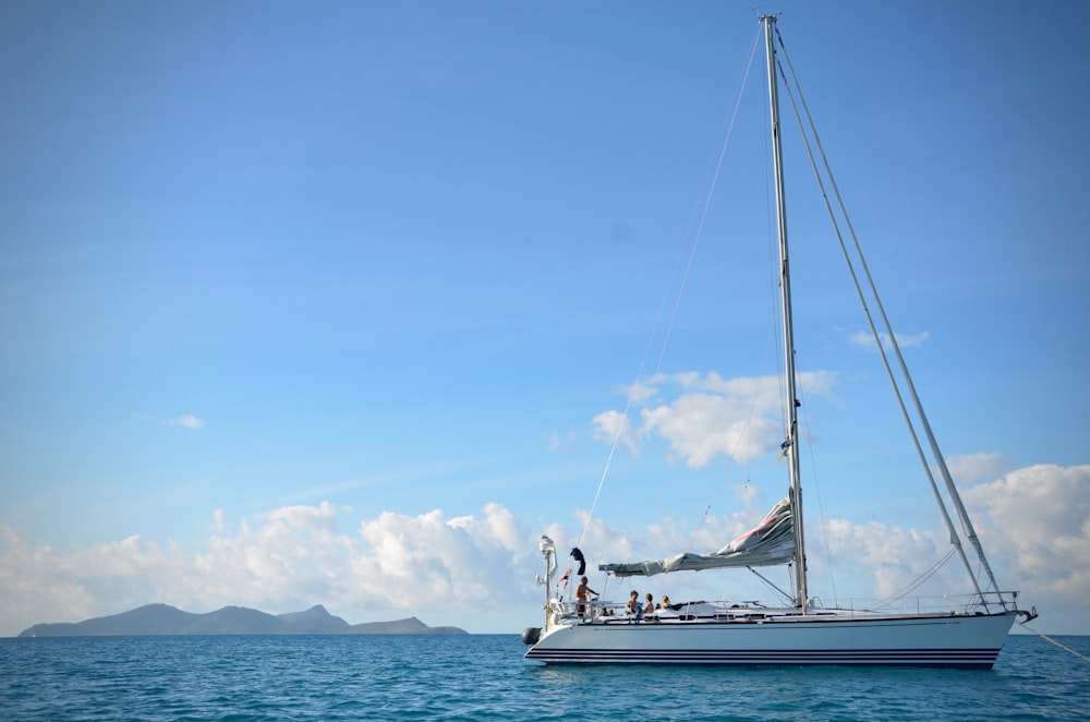 white sail boat on sea during daytime