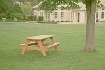 Close-up of stylish picnic tables arranged elegantly on a grassy lawn