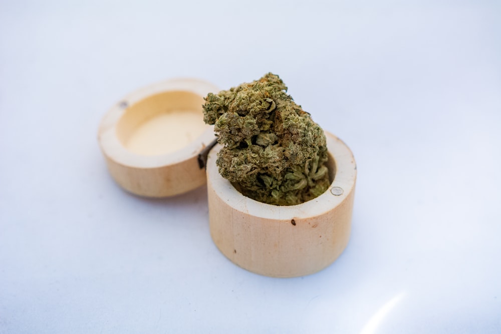 green kush on brown wooden bowl