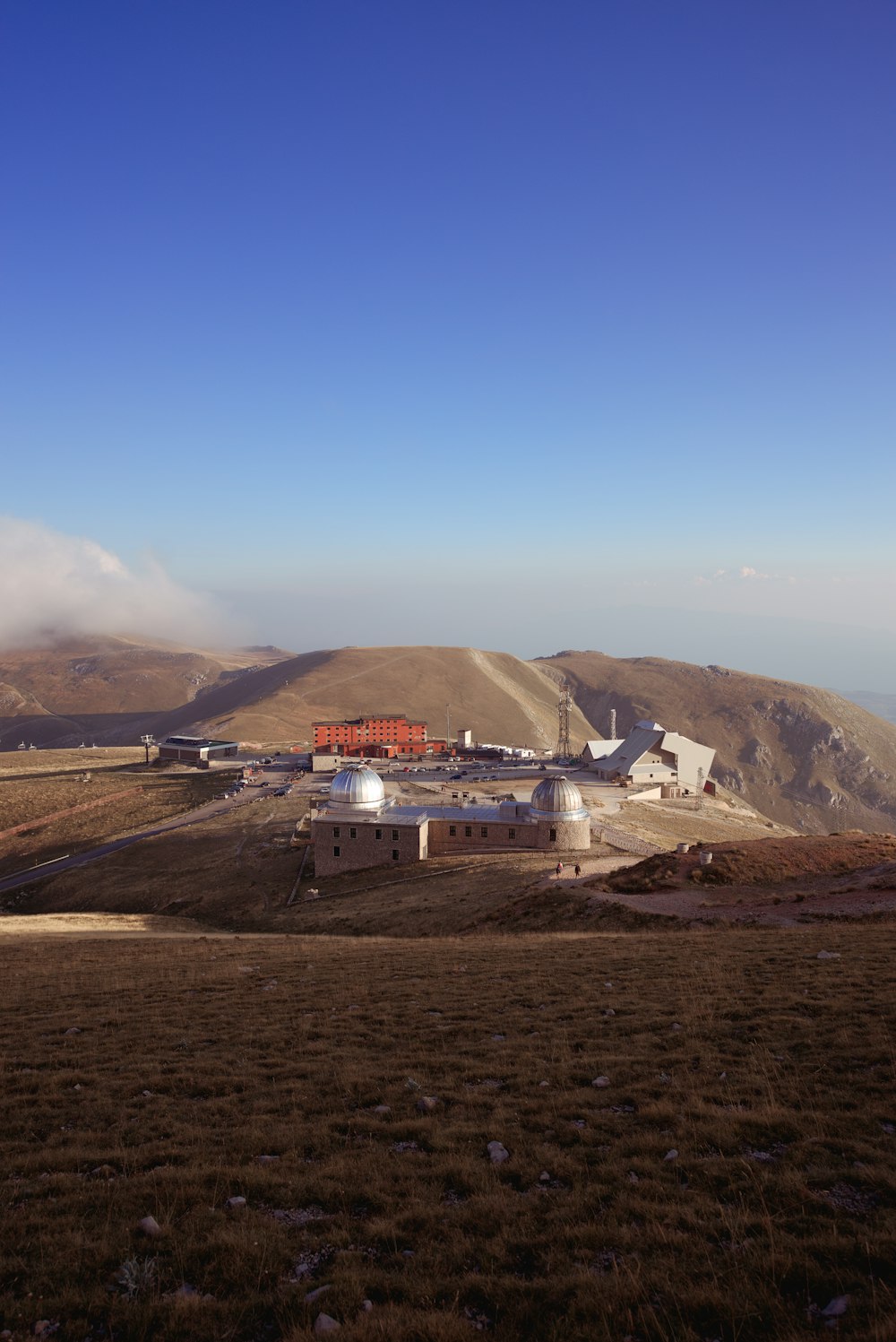 white and red building on top of mountain during daytime