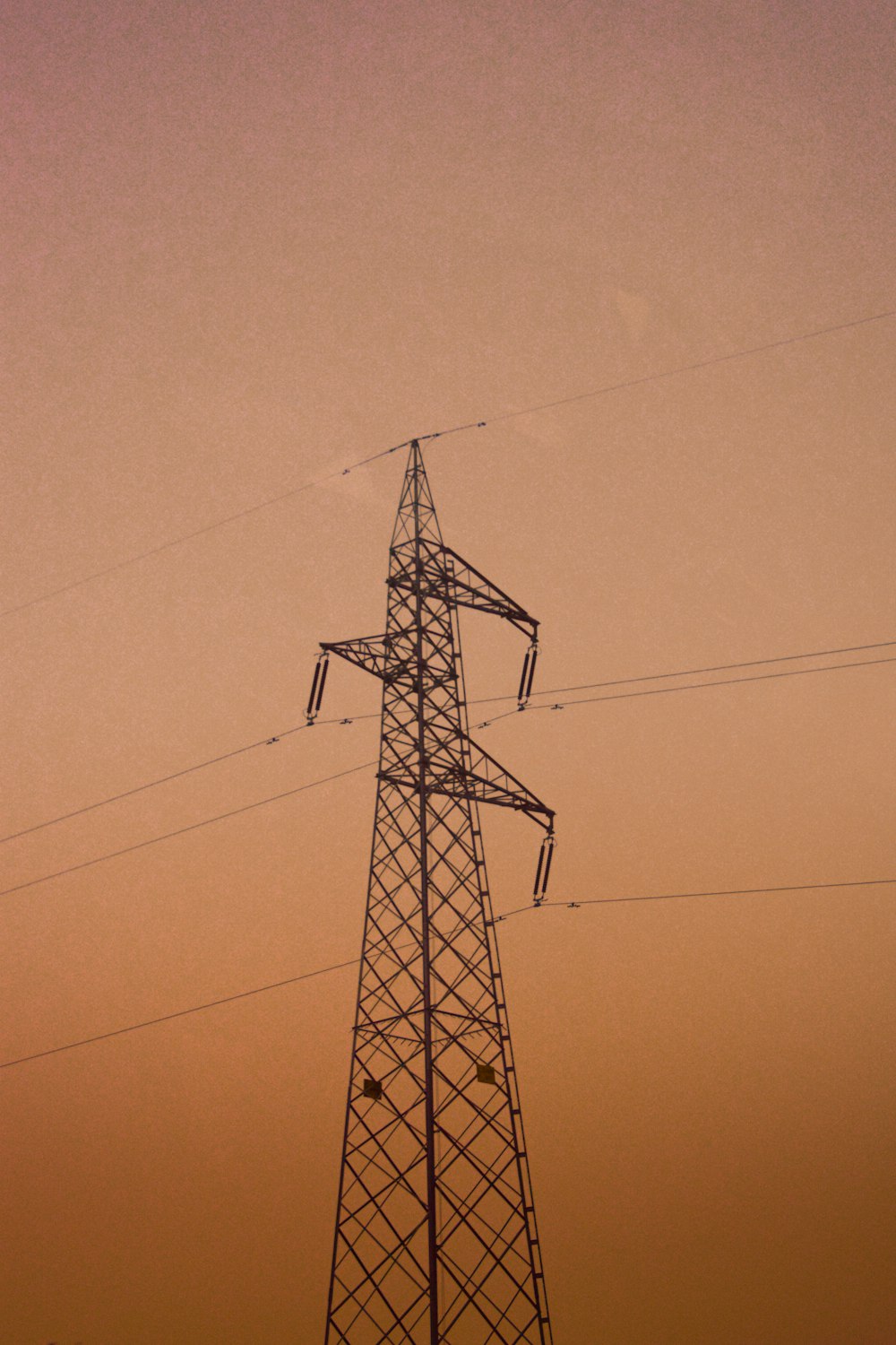 black electric tower under blue sky