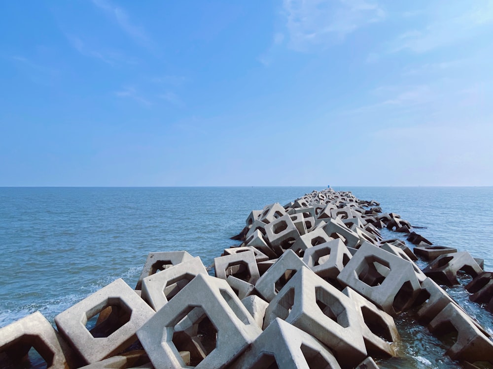 white concrete blocks near body of water during daytime