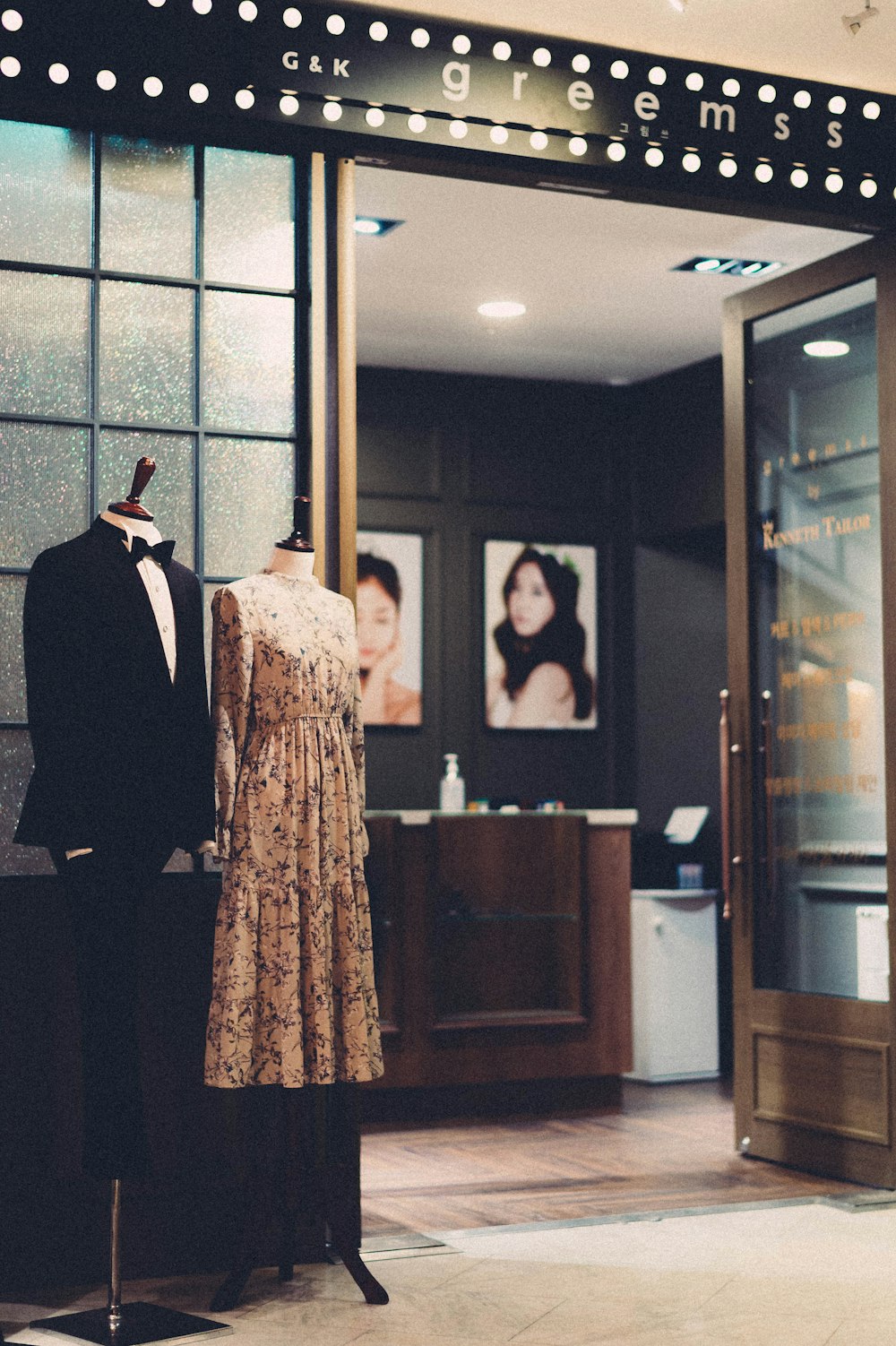 man in black suit standing near woman in brown dress