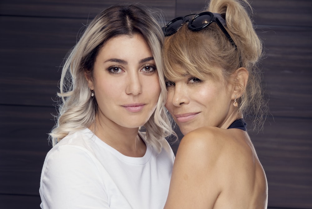 woman in white shirt beside woman in blue tank top