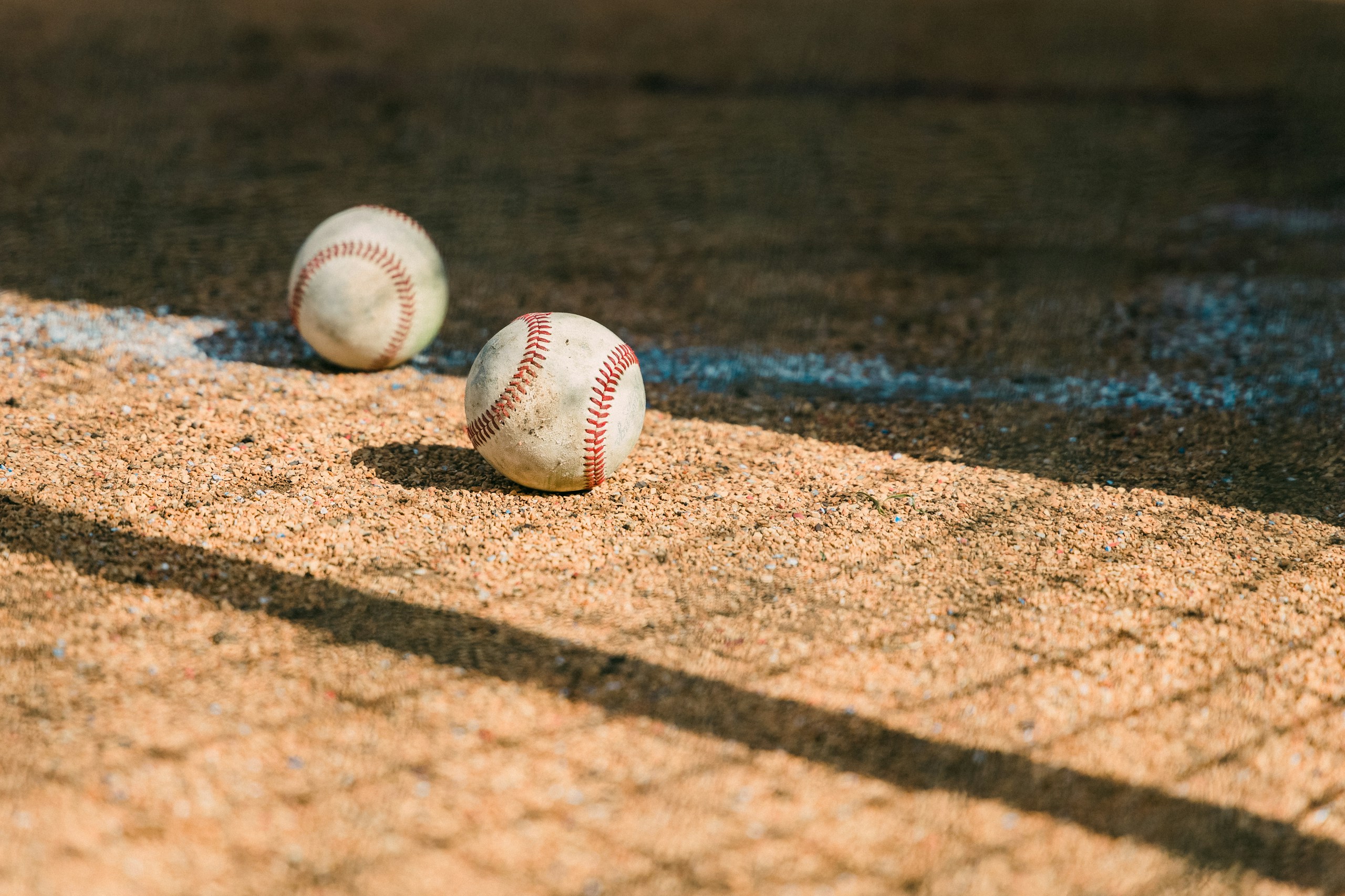 Jackals, white and red baseball on brown sand