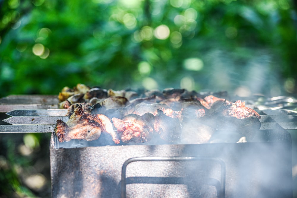 grilled meat on gray metal grill