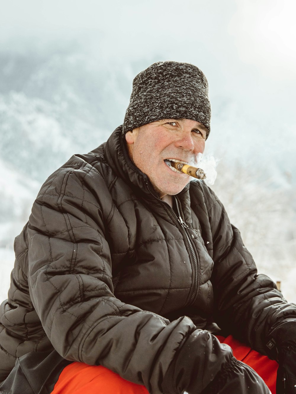 man in black jacket smoking cigarette