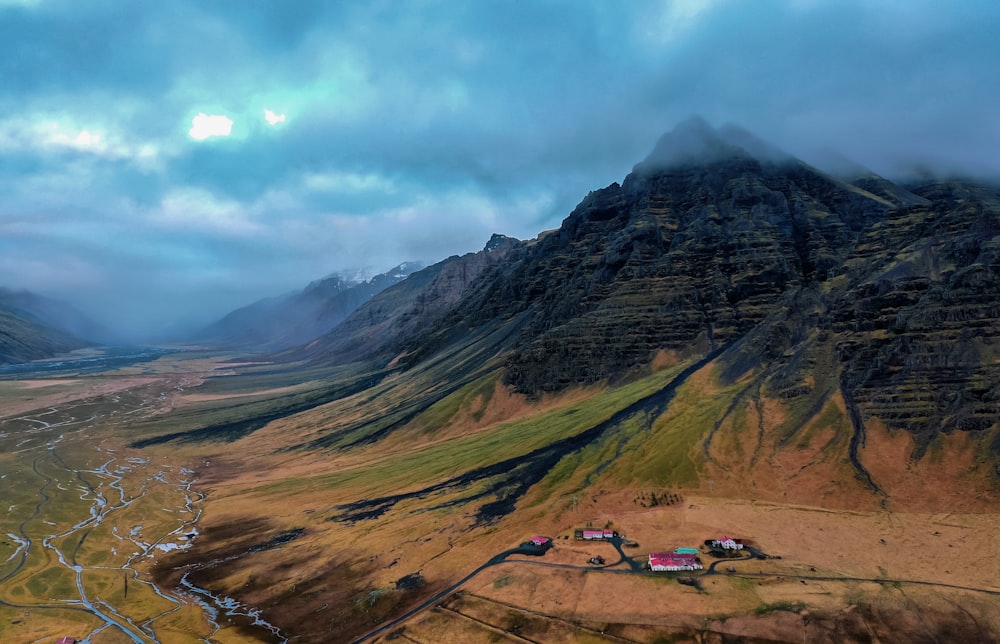 green and brown mountains under white clouds during daytime