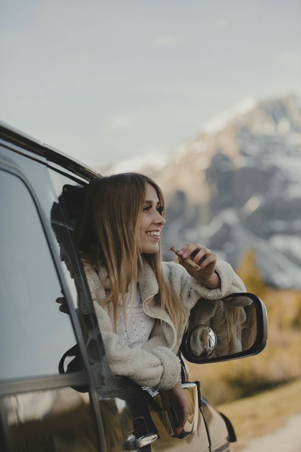 woman in white long sleeve shirt sitting on car seat