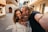 man and woman smiling while holding brown heart shaped balloons