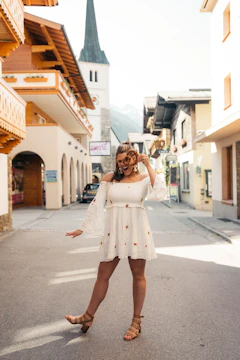 A traveler joyfully exploring a charming European street.