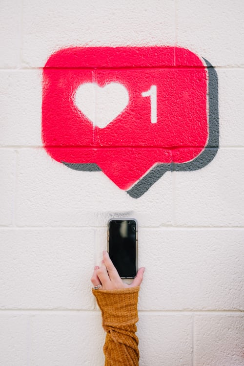 A stencil of the instagram like logo on a wall