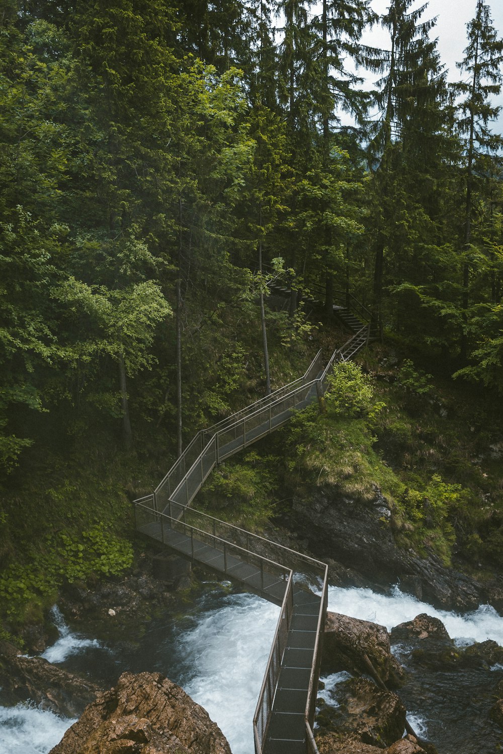 brown wooden bridge over river