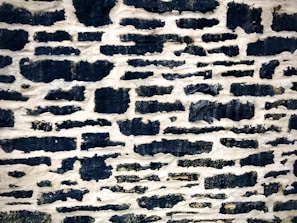 Close-up of a rustic stone division wall with natural textures and warm tones.