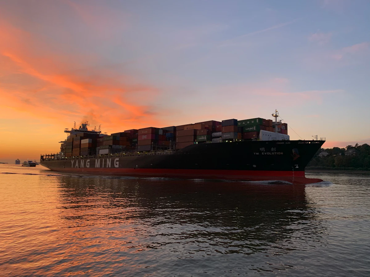 Cargo ship on calm water at sunset